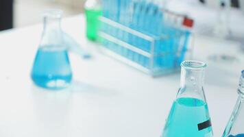Blue liquid in laboratory vials on a table video