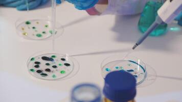 A person in a lab coat is holding a test tube video