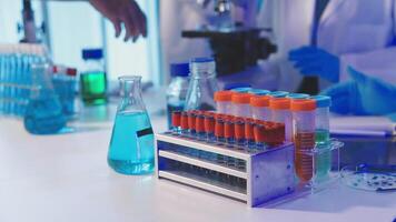 A laboratory with several test tubes and a person in a lab coat video