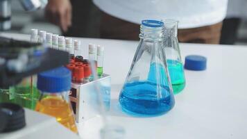 A person is standing in front of a laboratory with several test tubes video