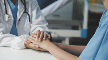 A doctor holding hands with a patient video
