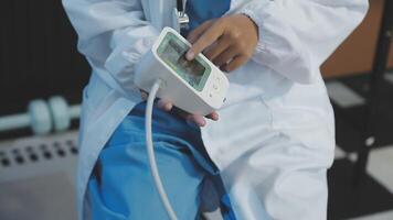 A doctor is holding a device with a cord video