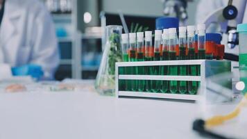 A laboratory with several test tubes and a person in lab coat video