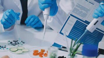 A group of people in lab coats and gloves are working on a project video