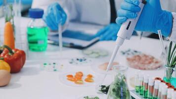 A person in a lab coat is holding a pipette video