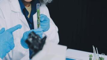 A woman in a lab coat is holding a tube video