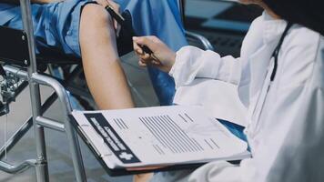 A doctor is examining a patient's knee video