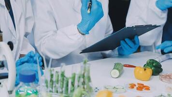 Scientists in lab coats and gloves working with food video