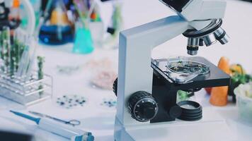 A microscope is on a table with other items video