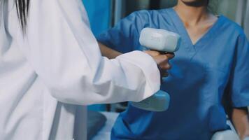 A woman in scrubs holding a dumbbell video