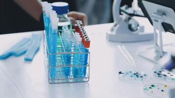 A person is working in a laboratory with a microscope video