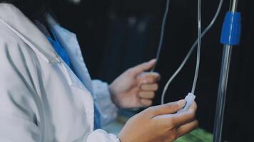A person in a lab coat is holding a tube video