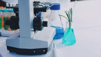A microscope and vials of liquid on a table video