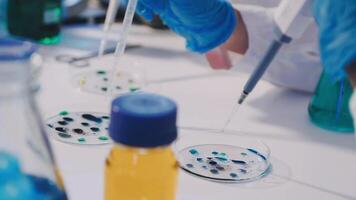 A person in a lab coat is working on a test tube video