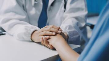 A doctor holding hands with a patient video