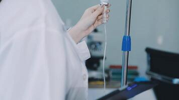 A person in a lab coat holding a tube video