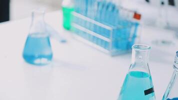 Blue liquid in laboratory flasks on table video