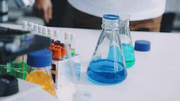 A person is standing in front of a laboratory with several test tubes video