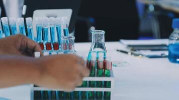 A person is holding a test tube with blue and green liquid video