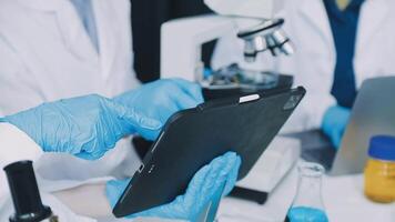 A man in a lab coat is holding a tablet video