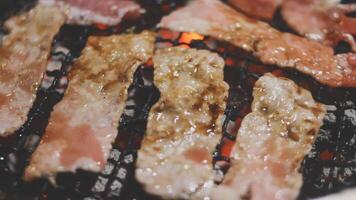 A close up of bacon being cooked on a grill video