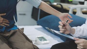 A doctor is talking to a patient on a bed video