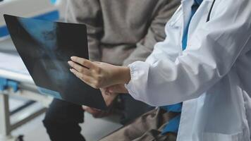 A doctor is holding a x - ray paper video