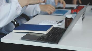 A doctor is using a laptop computer video