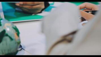 A person writing on a piece of paper with a pen video