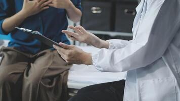 A doctor is talking to a patient on a tablet video