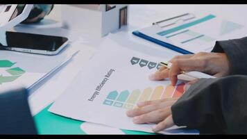 A business person is working on a report with a graph video