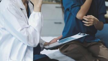 A doctor is talking to a patient on a bed video