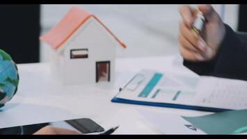 A real estate agent is working on a house with a globe and a pen video