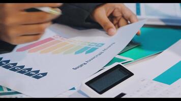 A person is using a calculator to calculate the value of a business video