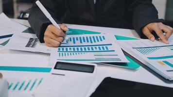 Business people working on papers with calculators video