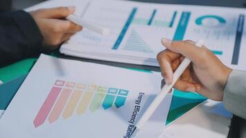 Business people working on a document with graphs video