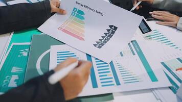 People are holding papers with graphs on them video