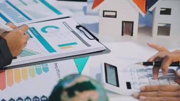 Business people working on a house model video