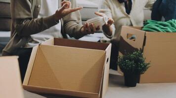 A man and woman are packing boxes in a room video