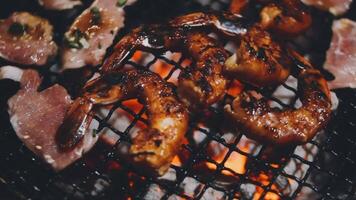 Grilled shrimp and meat on a grill video