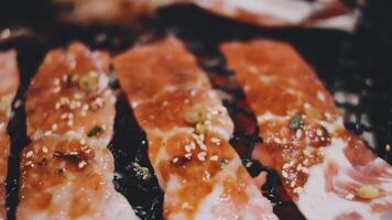 A close up of bacon on a grill video