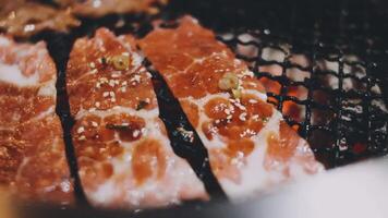 A close up of meat being cooked on a grill video