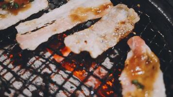 Bacon on a grill with sauce and herbs video