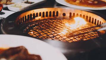 A grill with food on it and a fire video