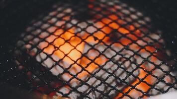 A close up of a grill with fire inside video