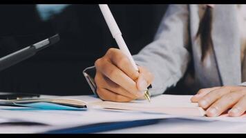A person is writing on a piece of paper with a pen video