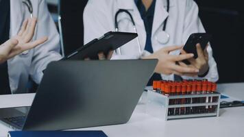 Two doctors are using their laptops and phones video