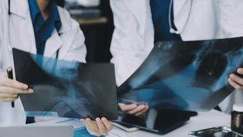 Two doctors looking at x - rays on a table video