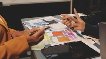 Two people working on a project at a desk video