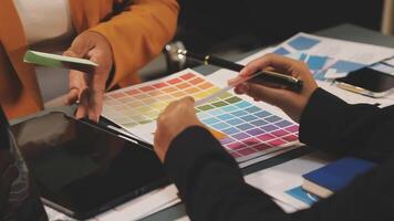 A business person is using a tablet to look at color swatches video